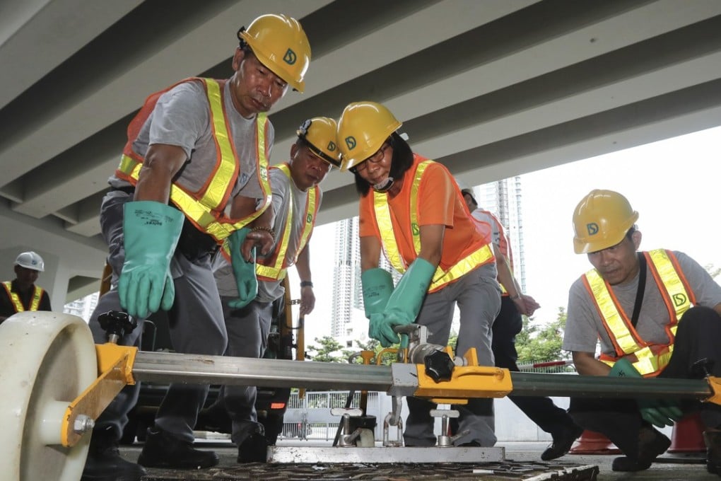 Chu Wan-chau (centre) and her team prepare to enter the sewers at Sai Wan Ho. Photo: Edward Wong