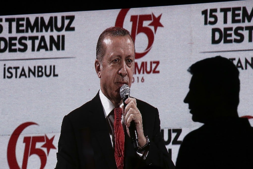 A screen displays Recep Tayyip Erdogan, Turkey's president, speaking during a rally on the anniversary of last year's failed coup. Photo: Bloomberg
