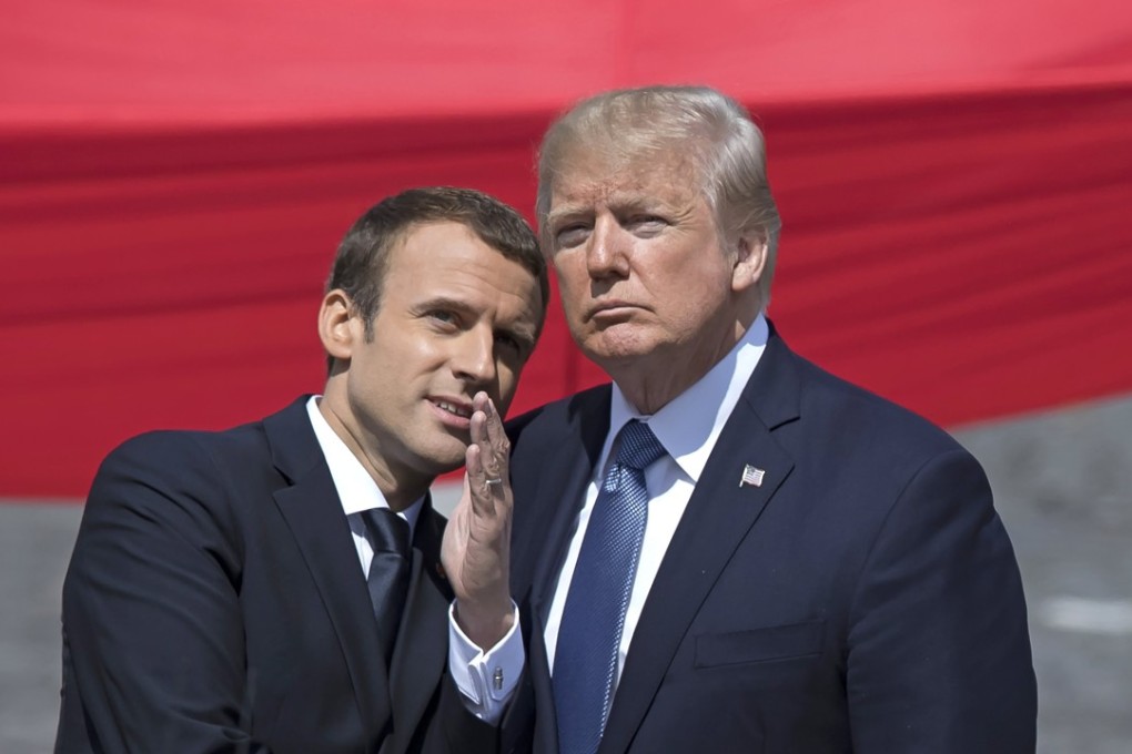 French President Emmanuel Macron (left) talks to US President Donald Trump while attending the traditional military parade as part of the Bastille Day celebrations in Paris. Photo: EPA