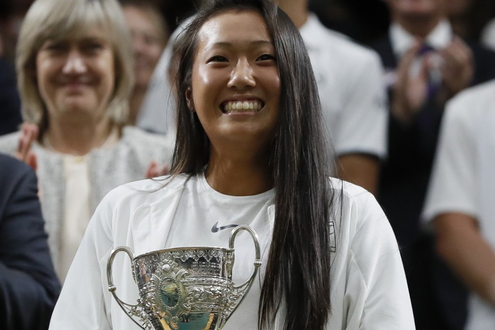 Claire Liu of the United States smiles as she holds up her winners trophy during a presentation in the Royal box. (AP Photo/Kirsty Wigglesworth)