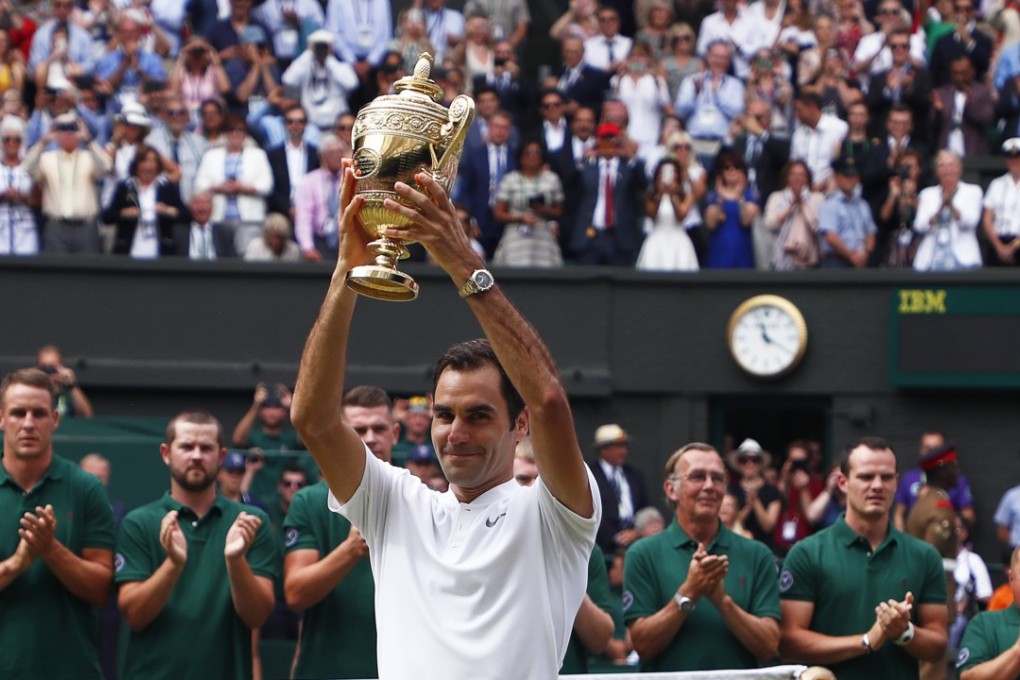 Roger Federer hoists the trophy after his victory over Marin Cilic, of Croatia. Photo: EPA