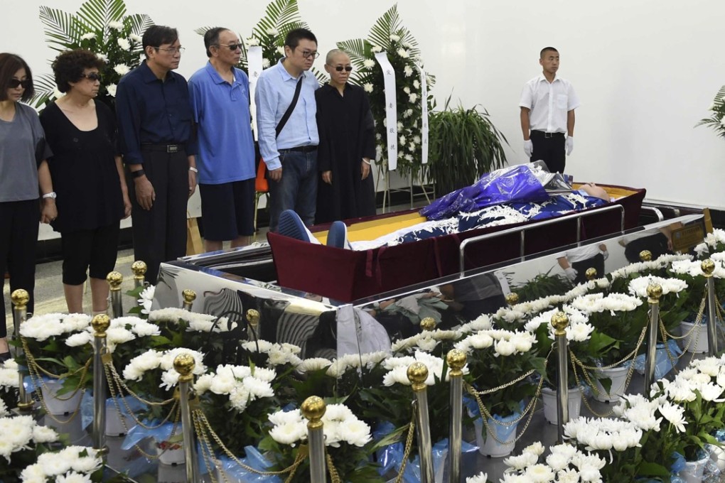 Liu Xia (right), widow of the late dissident Liu Xiaobo, is supported by her brother Liu Hui at the funeral service in Shenyang, Liaoning province on Saturday. Photo: AP