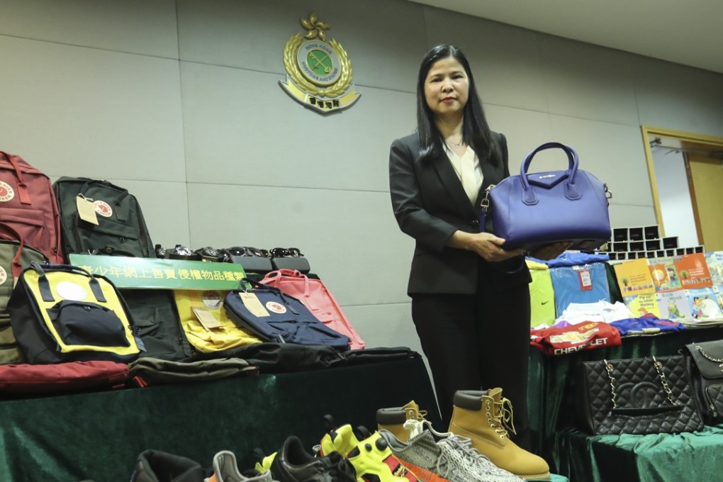 Catherine Yip, head of the intellectual property investigation bureau, with a few of the items that were seized. Photo: Edward Wong