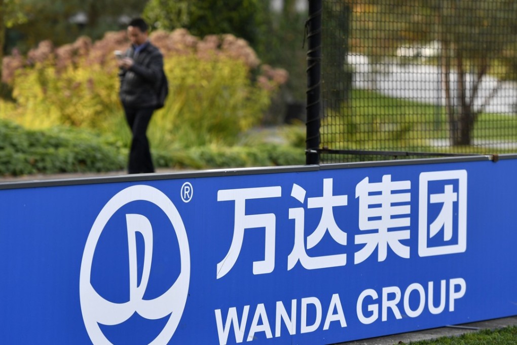 The sign and logo of Wanda Group, a Chinese multinational conglomerate corporation and FIFA partner, is seen on October 13, 2016 at the world football's governing body headquarters in Zurich. More Chinese joined the ranks of the super-rich this year, a survey showed on October 13, 2016, bringing the total to an all-time high despite dragging growth in the world's second-largest economy. Property and entertainment mogul Wang Jianlin, chairman of conglomerate Wanda Group, was tipped the richest man in China with a fortune of USD 32.1 billion, down two percent from a year ago, the survey said. Photo: AFP