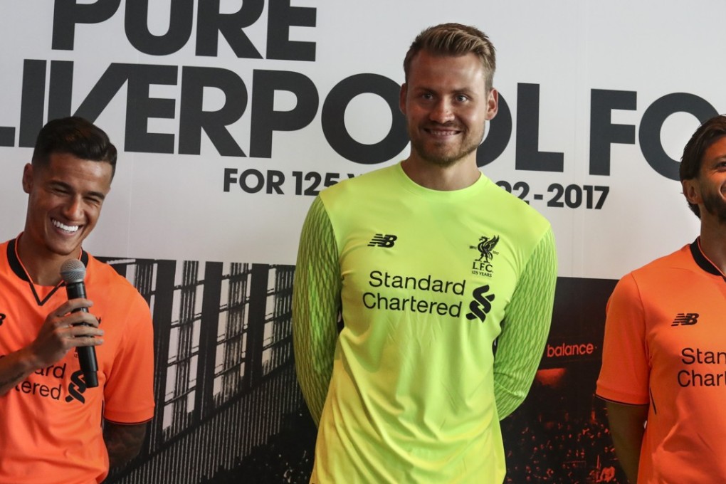 Philippe Coutinho (left), Simon Mignolet and Adam Lallana model Liverpool’s new third kit during a promotional event at the Ozone Bar. Photo: Nora Tam