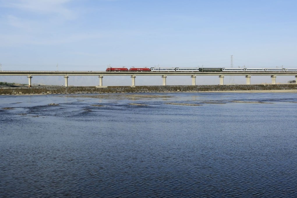 A train along the Heihe Bridge of the Lanxin High-speed Railway in Zhangye City in Gansu province. The 1,776-kilometer railway linking Lanzhou, capital of Gansu, and Urumqi, capital of Xinjiang, is one of the major passages for China's Belt and Road Initiative. Photo: Xinhua