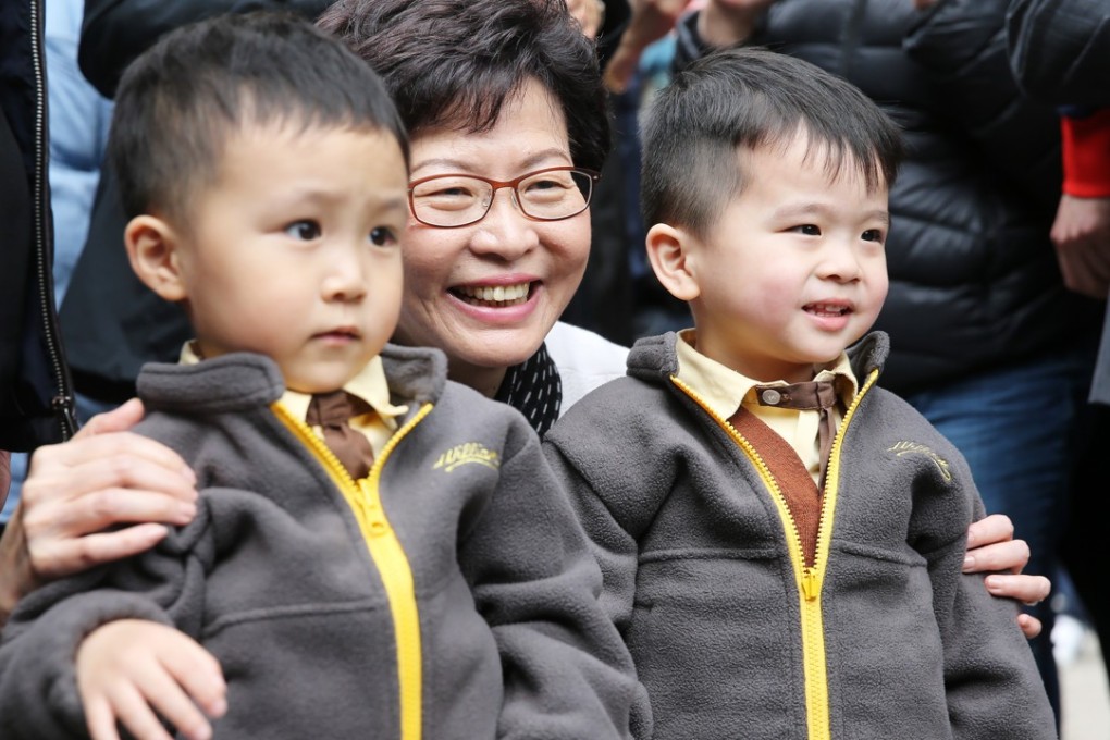 Then chief executive-elect Carrie Lam poses with young residents as she visits Hung Hom on March 27, a day after winning the election. Photo: Sam Tsang