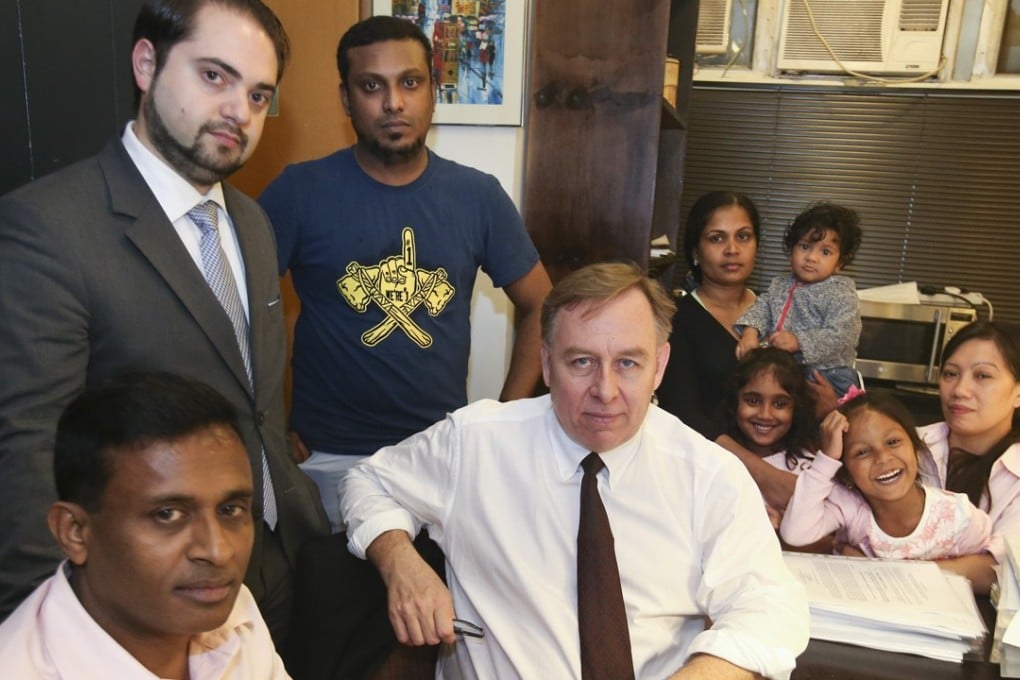 Lawyers Robbert Tibbo (centre) and Marc-Andre Seguin (left) with the seven asylum seekers. Photo: David Wong