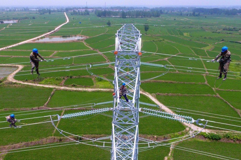 Workers check power lines during maintenance work in Laian, in China’s eastern Anhui province. Local governments are borrowing heavily to fund infrastructure projects to meet growth targets but have limited ways to bolster revenues. Photo: AFP