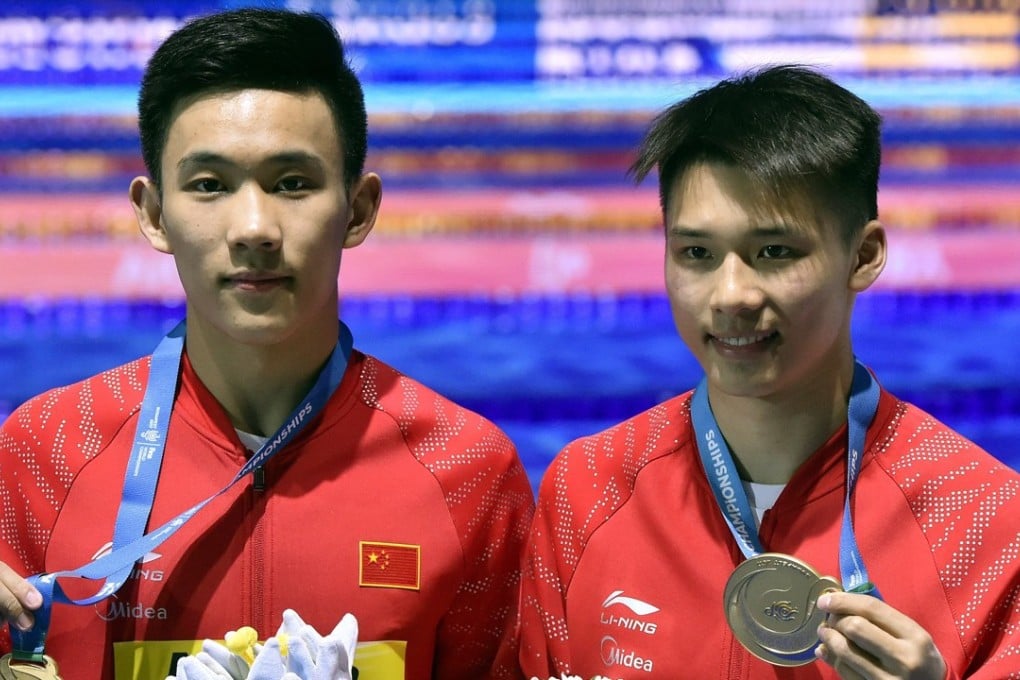 Yang Hao (left) and Chen Aisen pose with their medals. Photo: EPA