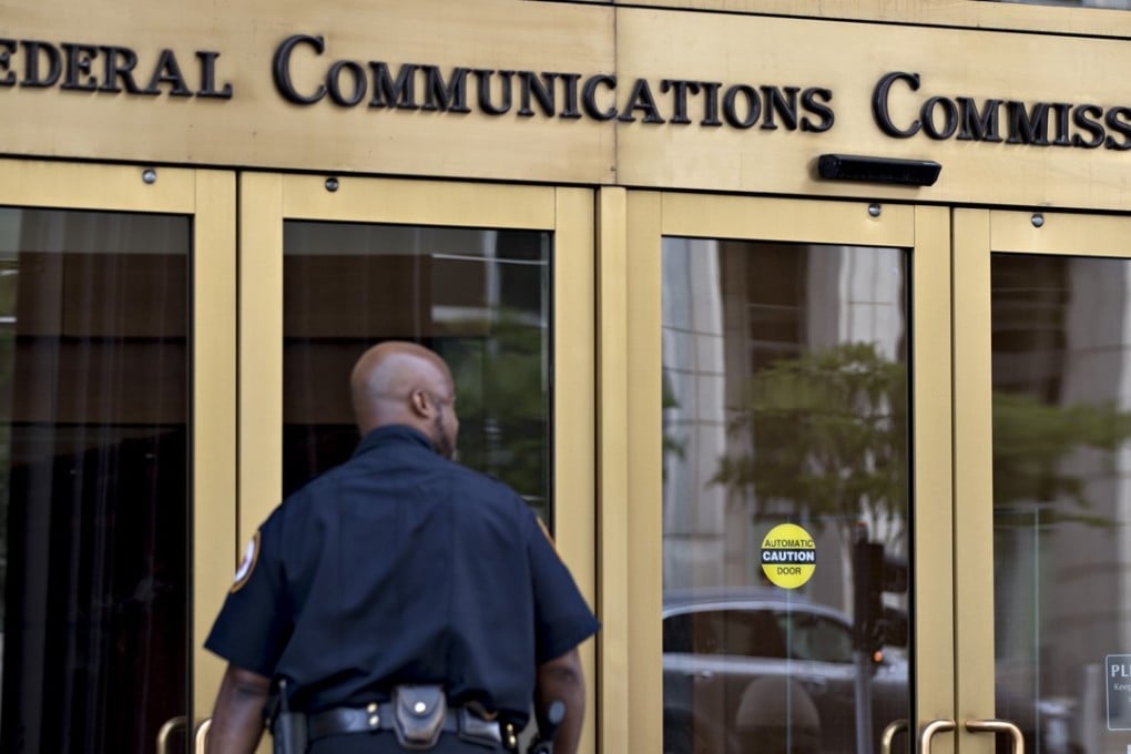 A security guard walks near the Federal Communications Commission (FCC) headquarters in Washington, DC. Tech giants such as Google and Microsoft are battling with telecom behemoths Verizon and AT&T over net neutrality rules in the US. Photo: Bloomberg