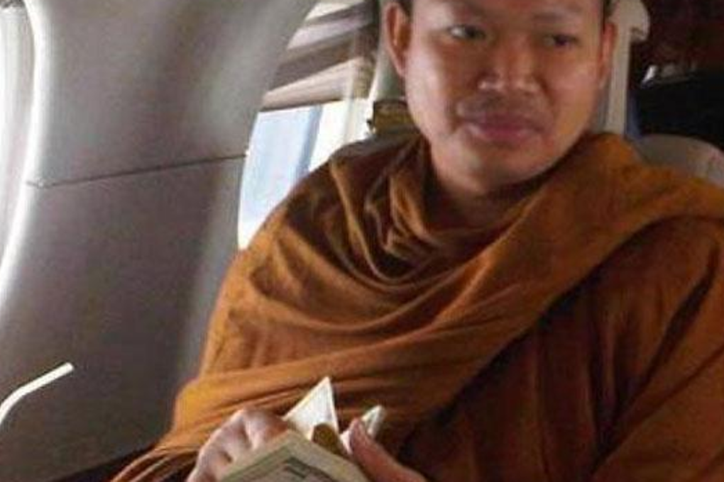 One of the early photos revealing then-monk Luang Pu Nem Kham, flaunting US currency while flying in a private jet. Photo: Facebook
