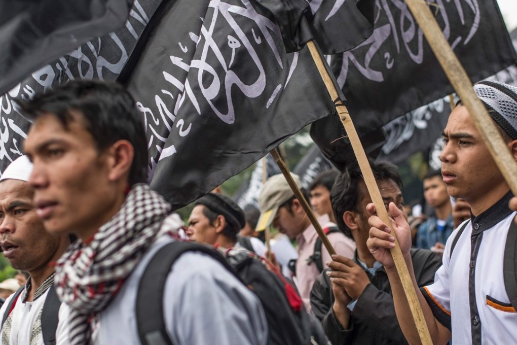 Indonesian Muslims wave Hizbut Tahrir’s flag during an anti-government rally in Jakarta. Photo: AFP