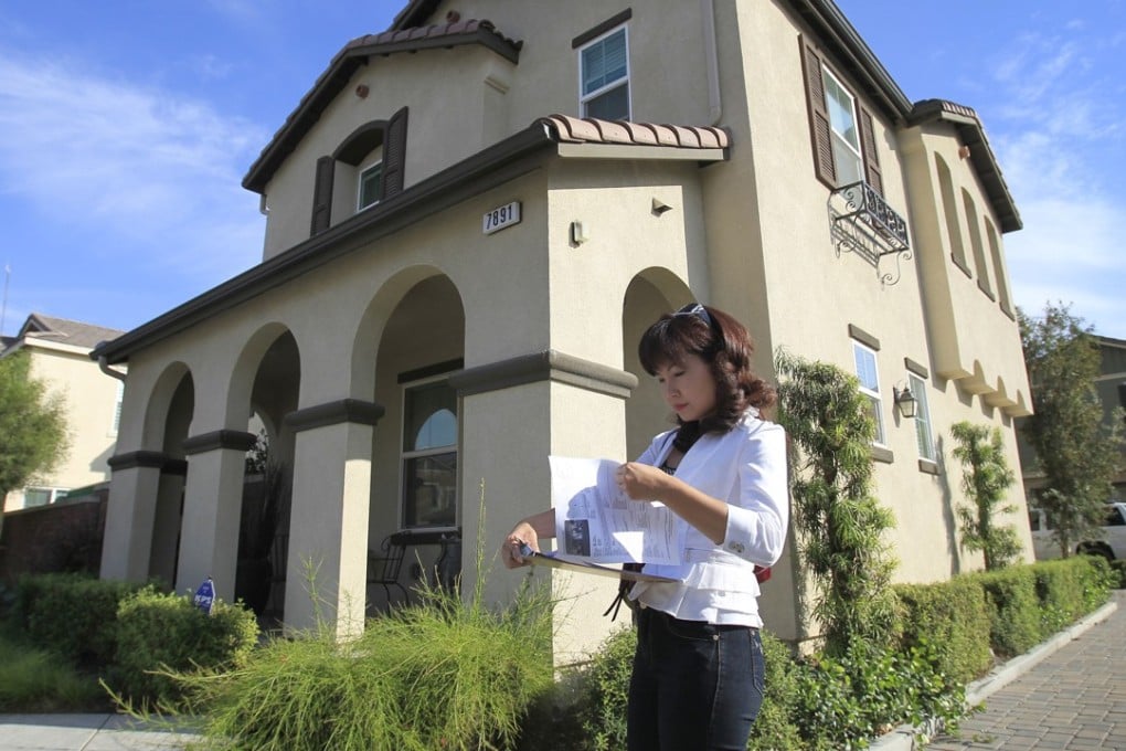 Alisha Chen, an agent in Irvine who specialises in buying houses for Chinese investors, checks her listings while touring homes for sale in Chino, California. Photo: MCT