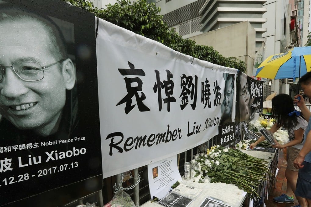 Mourners place offerings at a memorial for Liu Xiaobo outside the central government’s liaison office in Hong Kong on July 15. Liu died of liver cancer on July 13. Photo: Edward Wong