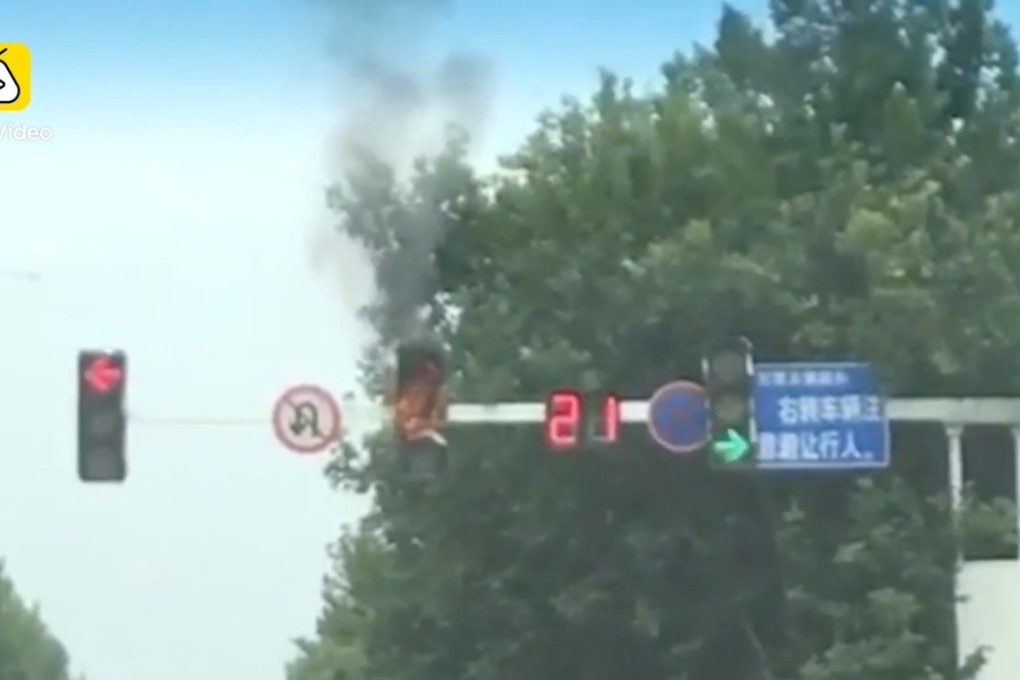 The traffic light in flames at an intersection in Feng county, Xuzhou. Photo: Handout