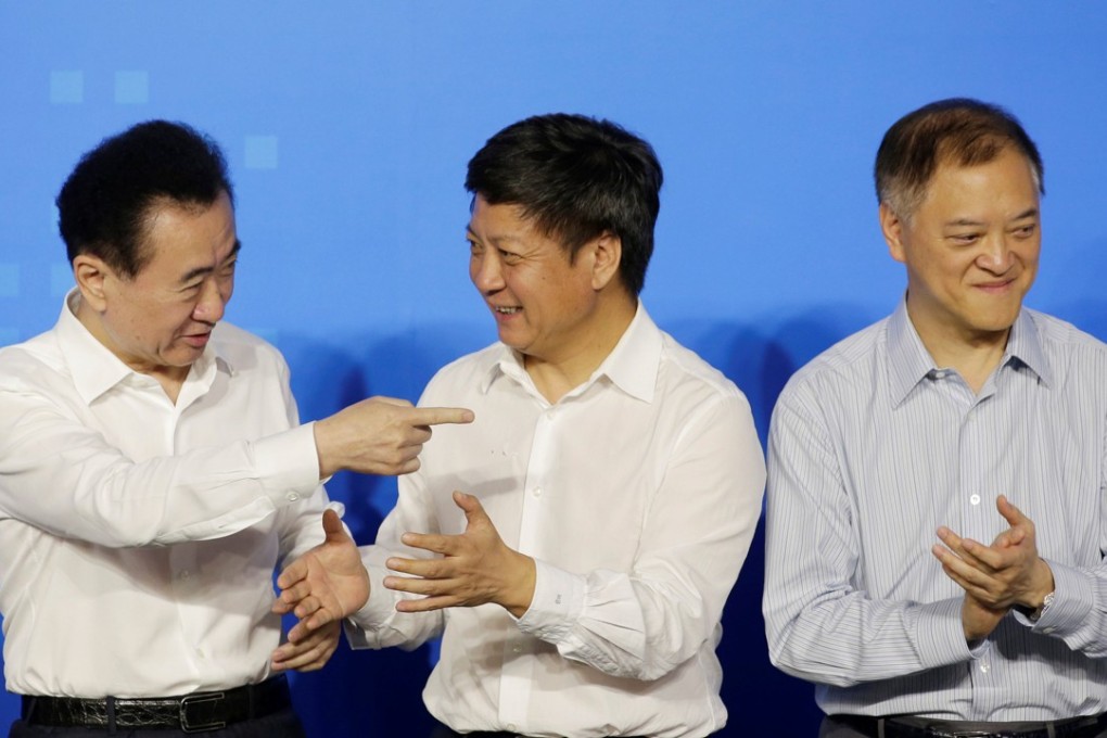 (From left) Wanda’s founder and chairman Wang Jianlin, Sunac China’s founder and chairman Sun Hongbin and R&F Properties’ Li Silian at their tripartite agreement to seal China’s largest real estate transaction, in Beijing on July 19, 2017. Photo: REUTERS/Jason Lee