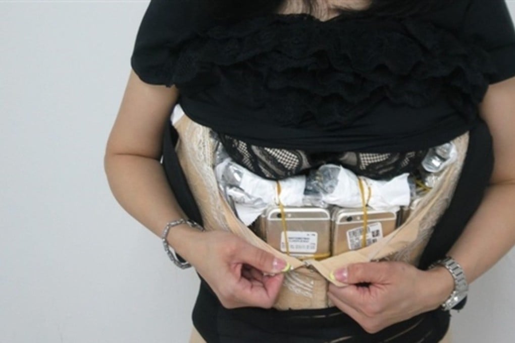 The iPhones and watches strapped to the woman’s body.