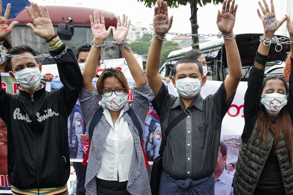 Reporters wearing masks and chains take part in a demonstration held to demand the release of detained journalists. Photo: EPA