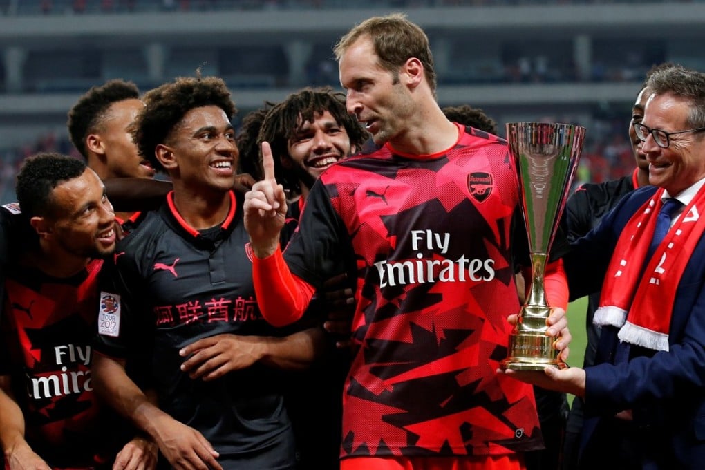 Arsenal's Petr Cech celebrates with the trophy and his teammates after the match. Photo: Reuters