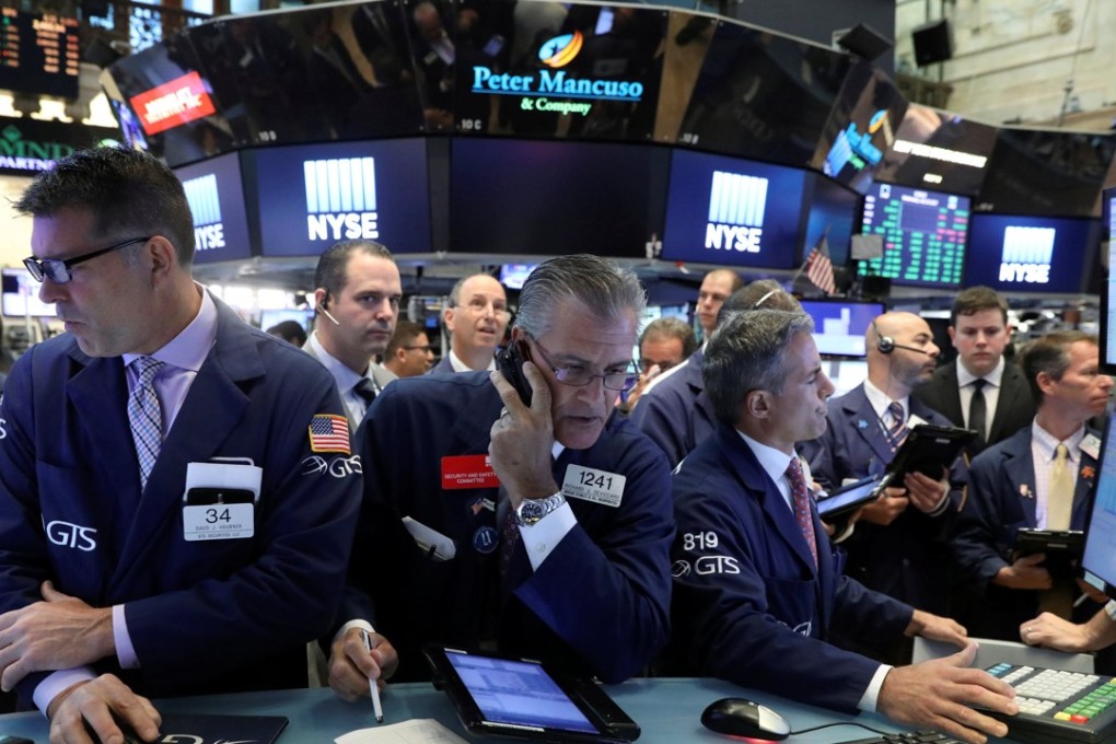 Traders scramble to fill their orders as Wall Street surged to new highs on the back of strong tech stocks. Photo: Reuters