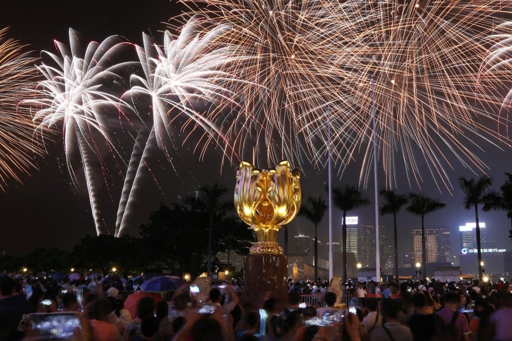 Fireworks explode over Victoria Harbour and the Golden Bauhinia as Hong Kong celebrates the 20th anniversary of its handover, on July 1. Nora Tam