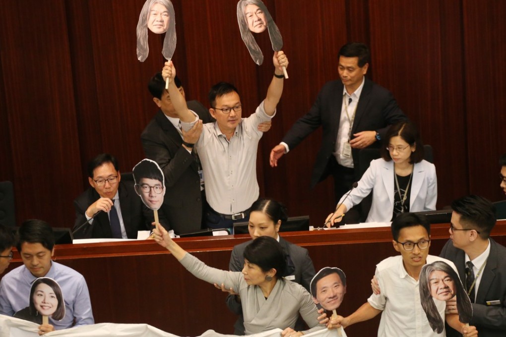 Pro-democracy lawmakers during the Finance Committee meeting, protesting over the disqualification of four legislative councillors. Photo: David Wong
