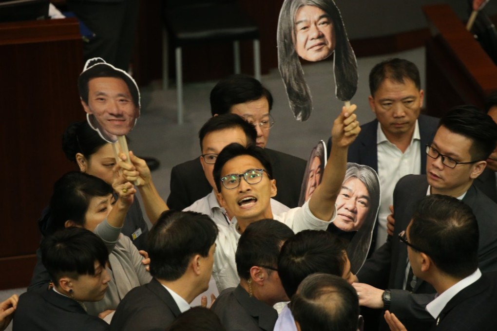 Eddie Chu (centre) protests during the Legco Finance Committee meeting. Photo: David Wong