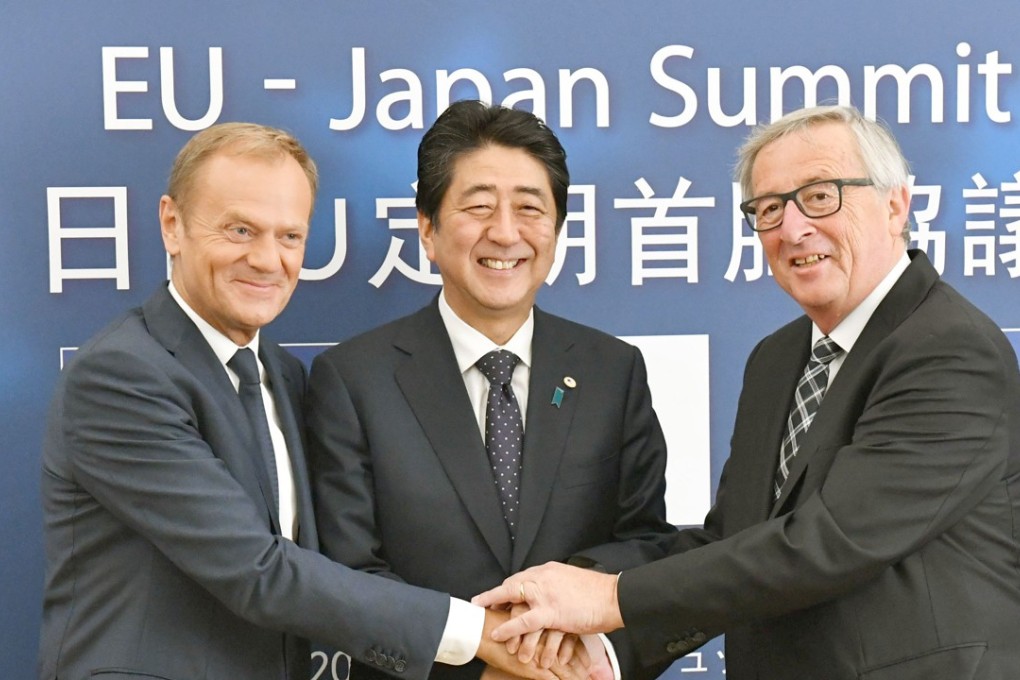 From left, European Council President Donald Tusk, Japanese Prime Minister Shinzo Abe and European Commission President Jean-Claude Junker shake hands in Brussels. Photo: Kyodo