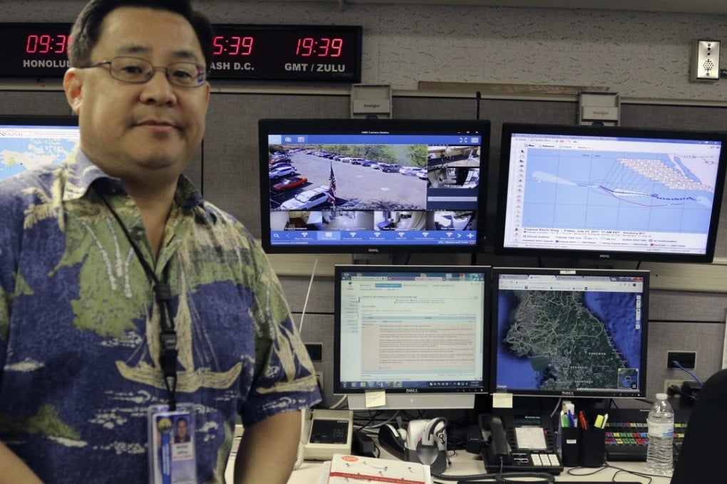 Jeffrey Wong, of the Hawaii Emergency Management Agency, next to computer screens monitoring hazards at the agency’s headquarters in Honolulu. Photo: AP