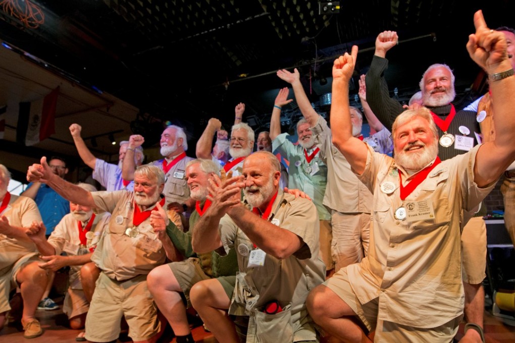Hemingway Lookalike Contest semi-finalists acknowledge the audience at Sloppy Joe's Bar. Photo: Reuters