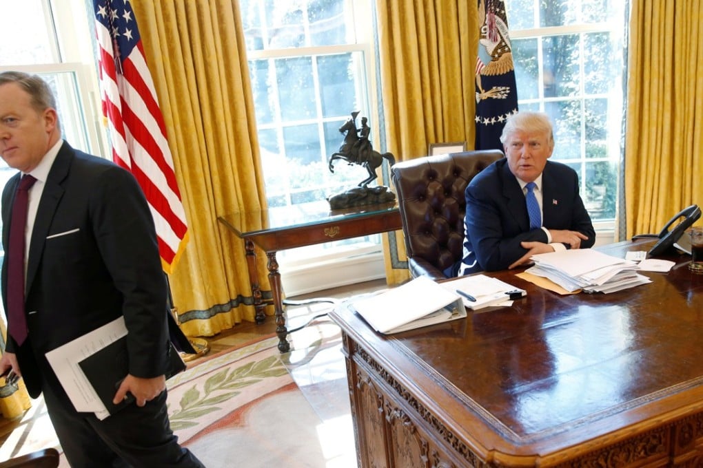 White House communications director and spokesman Sean Spicer walking away from US President Donald Trump. Photo: Reuters