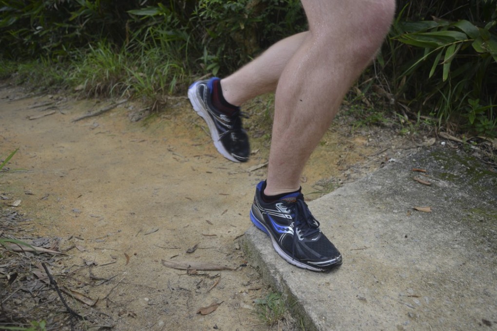 Mark Agnew transitions from trail to concrete as he runs the Jardine’s Peak trail on Hong Kong Island. Photo: Antony Dickson