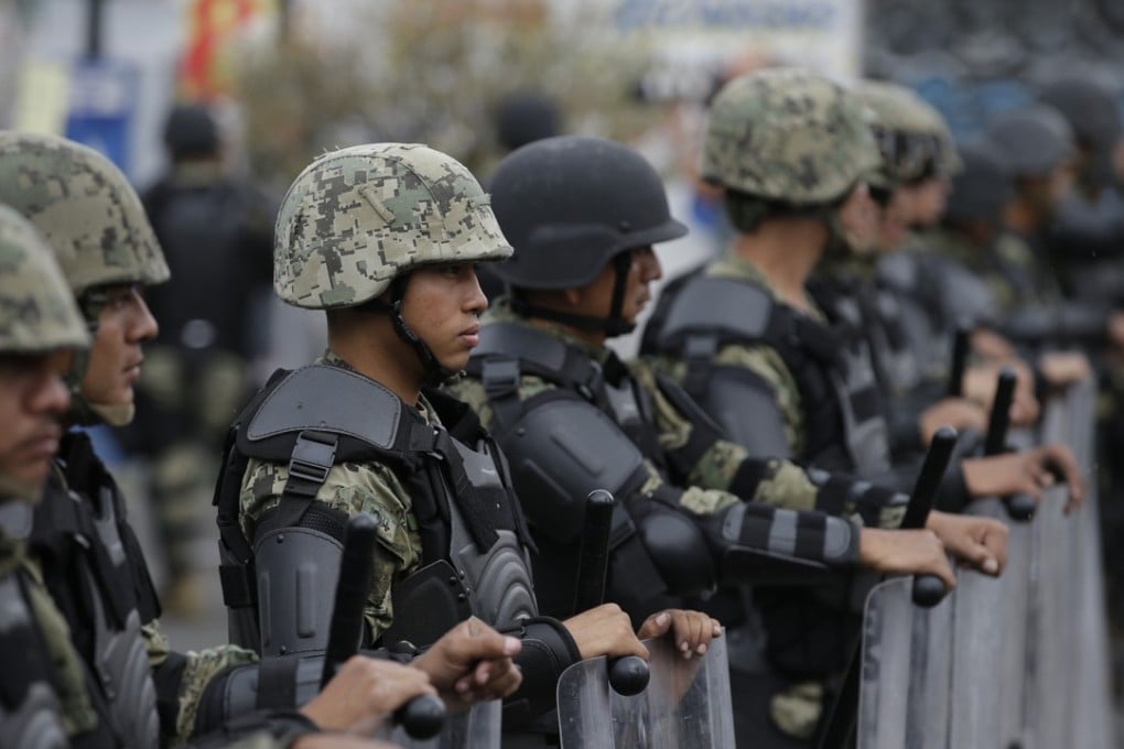 Marines block access to the site where the suspected leader of a drug gang and seven others were killed. Photo: AP