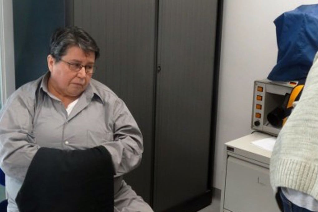 Azra Basic being processed by a law officer in 2016. She is among about 12 women charged or convicted of crimes committed during Bosnia’s inter-ethnic war in the 1990s which claimed nearly 100,000 lives. Photo: AFP
