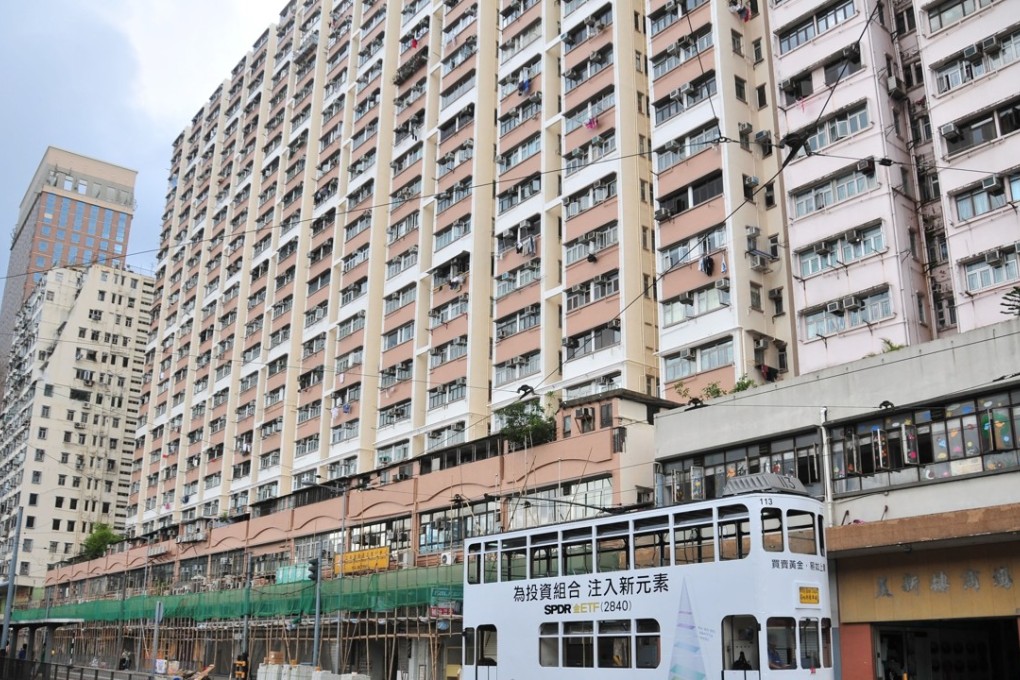 Tram travelling along Des Voeux Road West, past apartments with bamboo scaffolding, Kennedy Town. Photo: SCMP