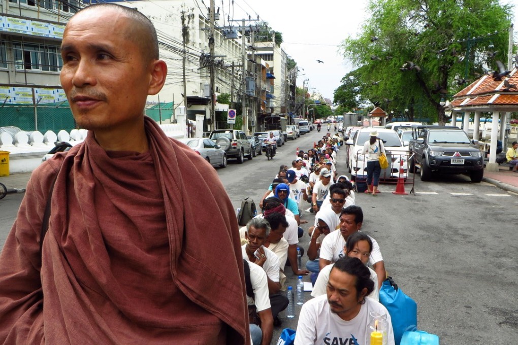 Dadodin Patavatto a Buddhist monk, leads a silent march to the prime minister's office in Bangkok to demonstrate against a proposed coal power plant in southern Thailand. The plans for an 800-megawatt coal power plant have sparked an outcry in the typically tranquil Krabi province, famed for its white sand and picturesque limestone cliffs. Photo: AP