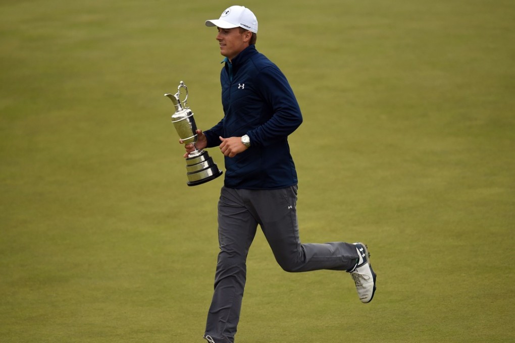 Jordan Spieth runs to share the Claret Jug with spectators after claiming the Open Championship title in Southport. Photo: AFP
