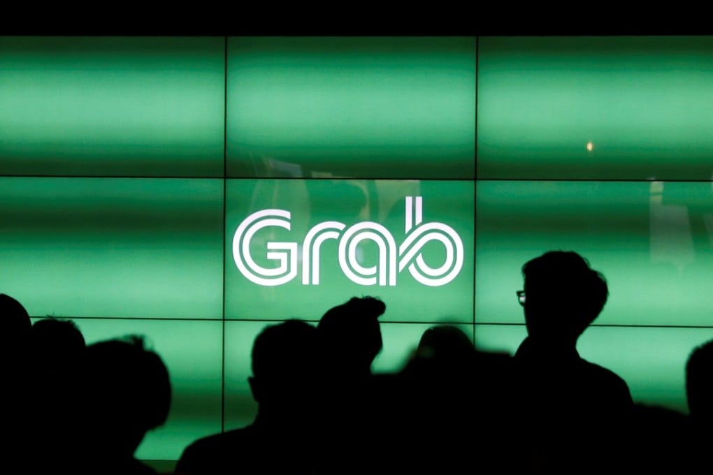 People wait for the start of ride-hailing company Grab's fifth anniversary news conference in Singapore. Photo: Reuters