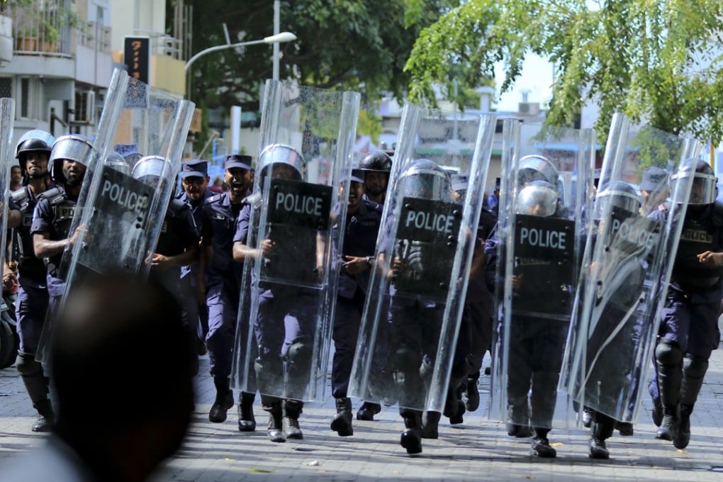 Police block the road leading to the Parliament building in Male, Maldives. Photo: AP