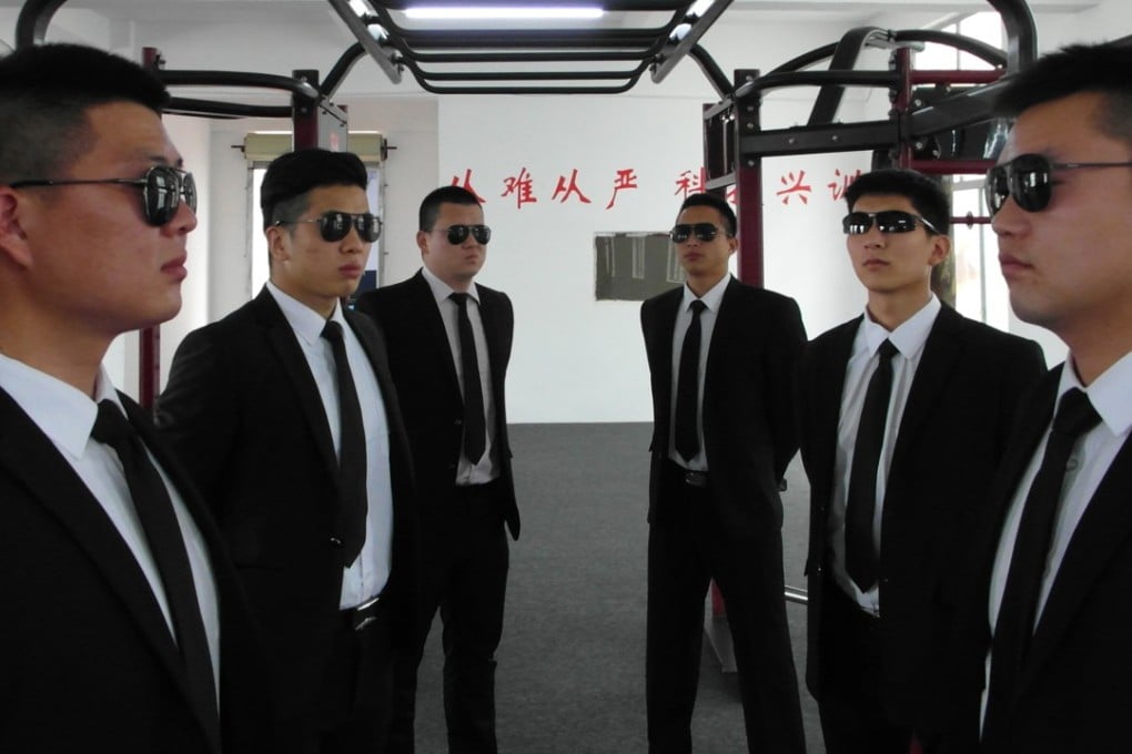 Security guards from Zhongzhou Bodyguard pose in suits and shades in the company gym in Shenzhen. The firm has been looking after China’s business leaders for the past 11 years. Photo: Handout