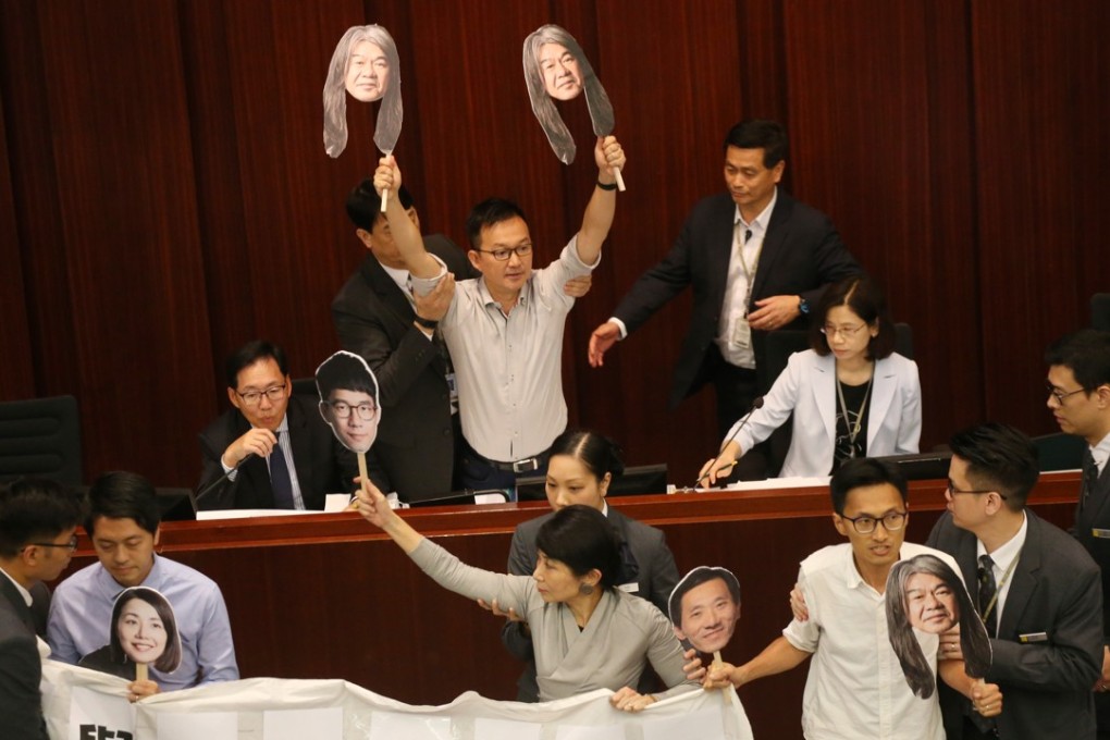 Pro-democracy lawmakers protest against the disqualification of four colleagues. Photo: David Wong