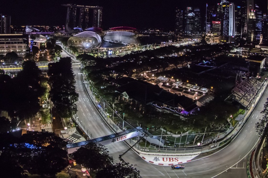 The Formula One Singapore Grand Prix dominates the night sky, with a view of Padang and Turn 9 at Marina Bay Street Circuit.