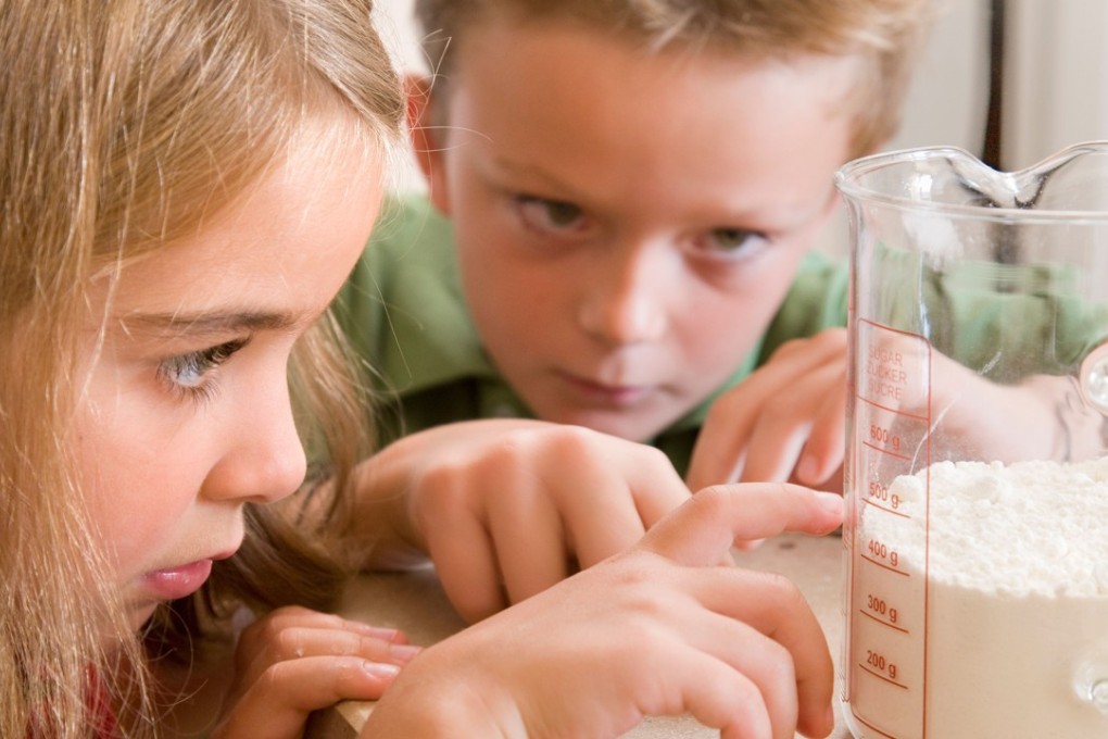 Find creative ways to keep maths in a child’s mind over the summer holiday, such as measuring flour for baking. Photo: Alamy