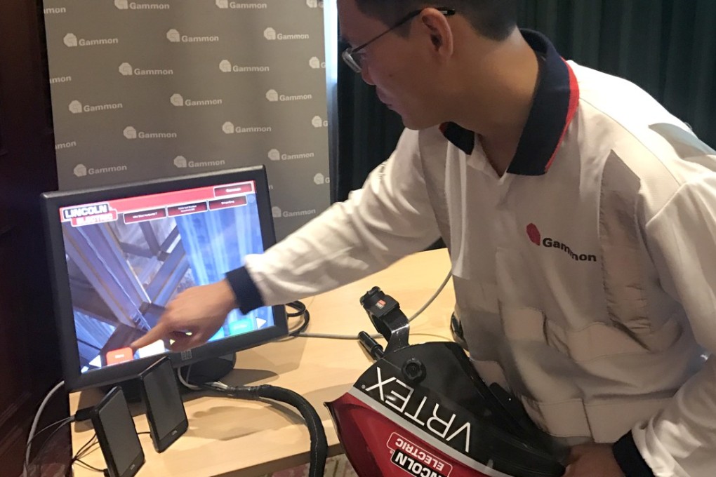 A staff member operates a virtual reality training device for welders. Photo: Tracy Zhang
