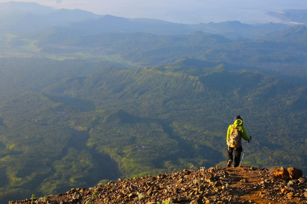 Hiking guide Wayan Ariana contemplates the views of Bali’s coastline on the descent of Mount Agung. Photo: Graeme Green