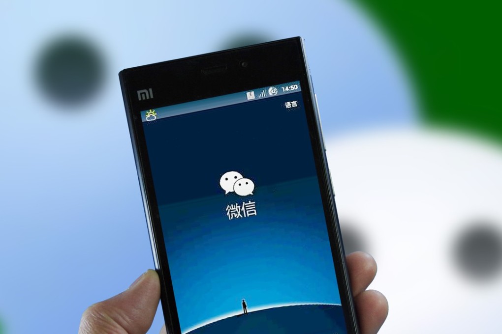 A mobile phone user displays WeChat. Photo Imaginechina
