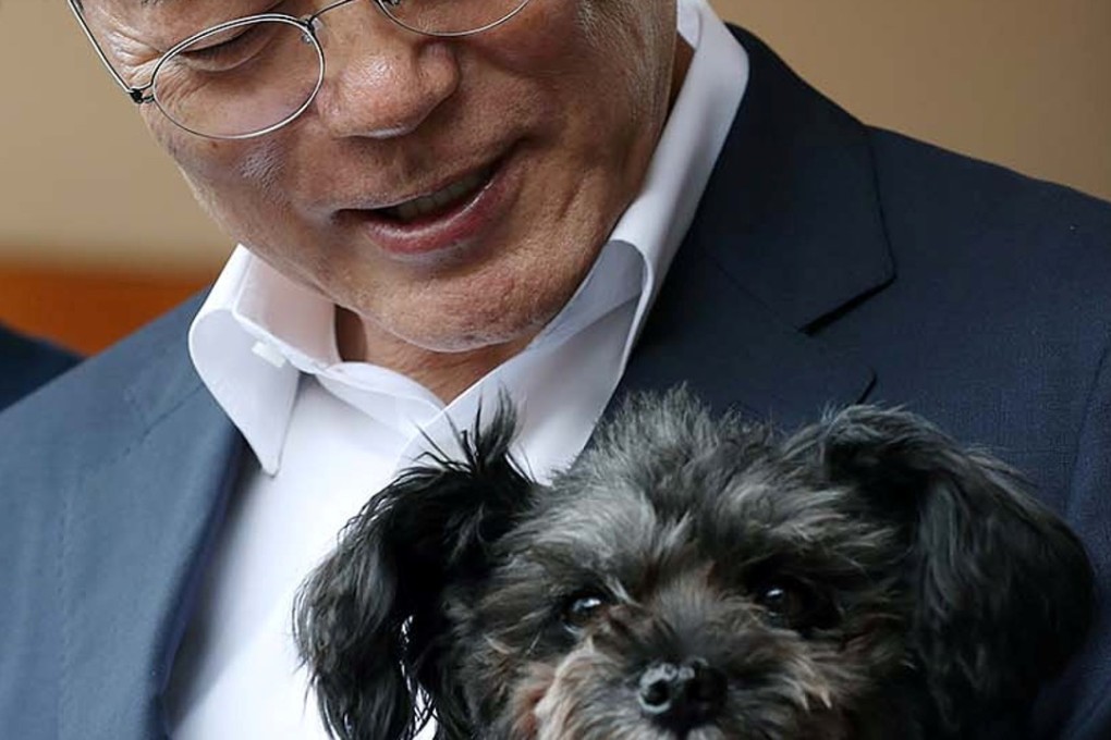 South Korean President Moon Jae-in holding the adopted rescue dog. Photo: Reuters