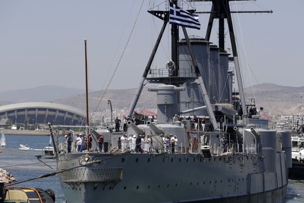 Tugs pull the 107-year-old battleship" Georgios Averof" to Trocadero marina in southern Athens on Wednesday, July 26, 2017. After three months of extensive maintenance and conservation work, a relic of the era of dreadnoughts is back in its berth in Athens, where it serves as a floating museum. Photo: AP