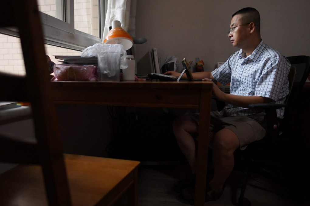 Qiao Mu, pictured at his desk at his home in Beijing, where he now makes a living from essays posted on WeChat. Photo: AFP